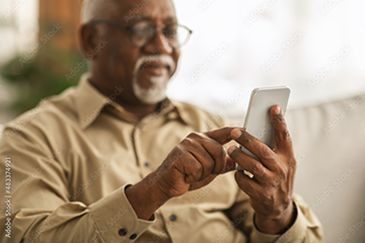 Senior using smartphone with caregiver help